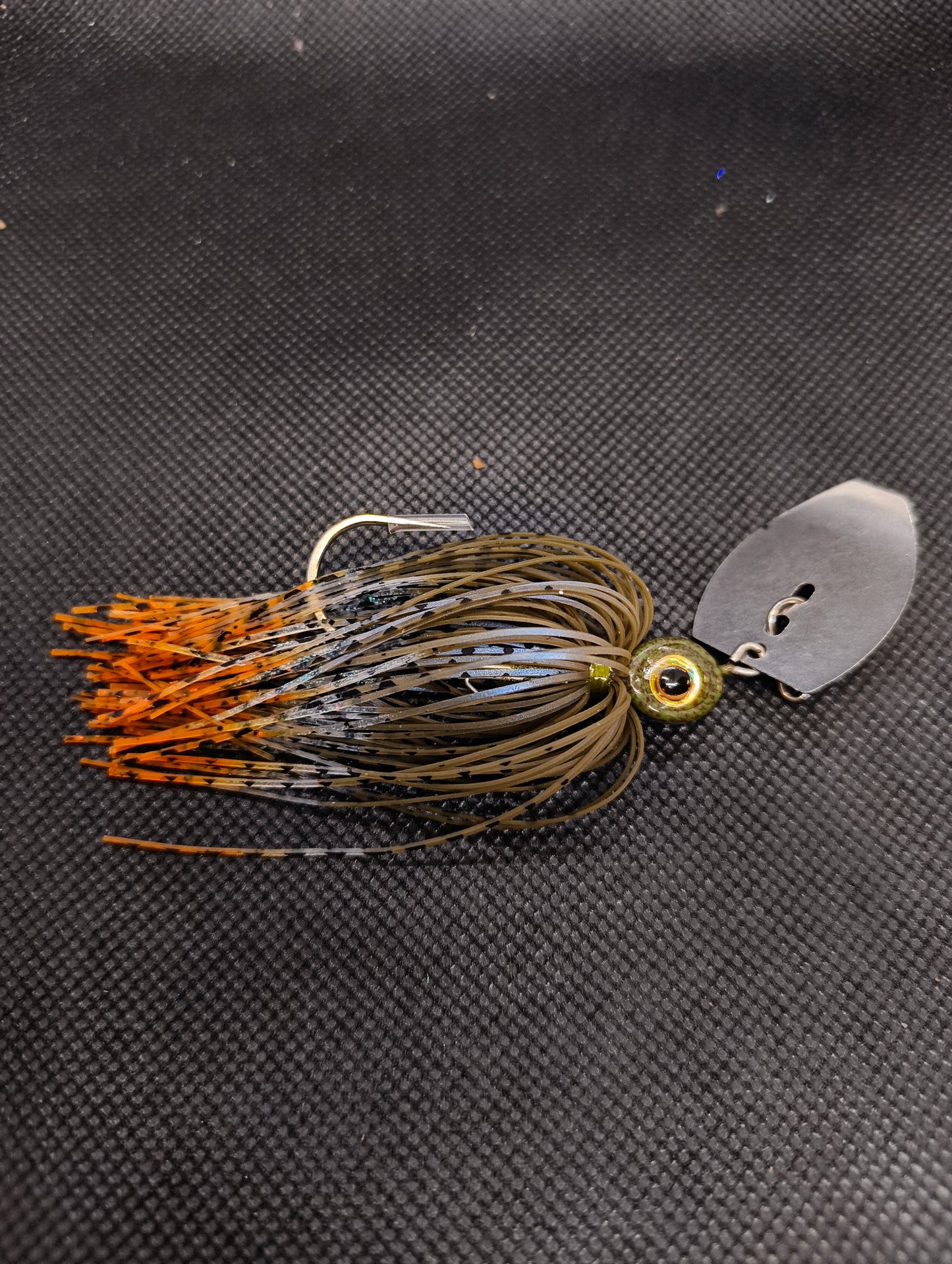 Limestone Softbaits ShadShaker chatter bait with green and black jig head and curly tail soft plastic for fishing.
