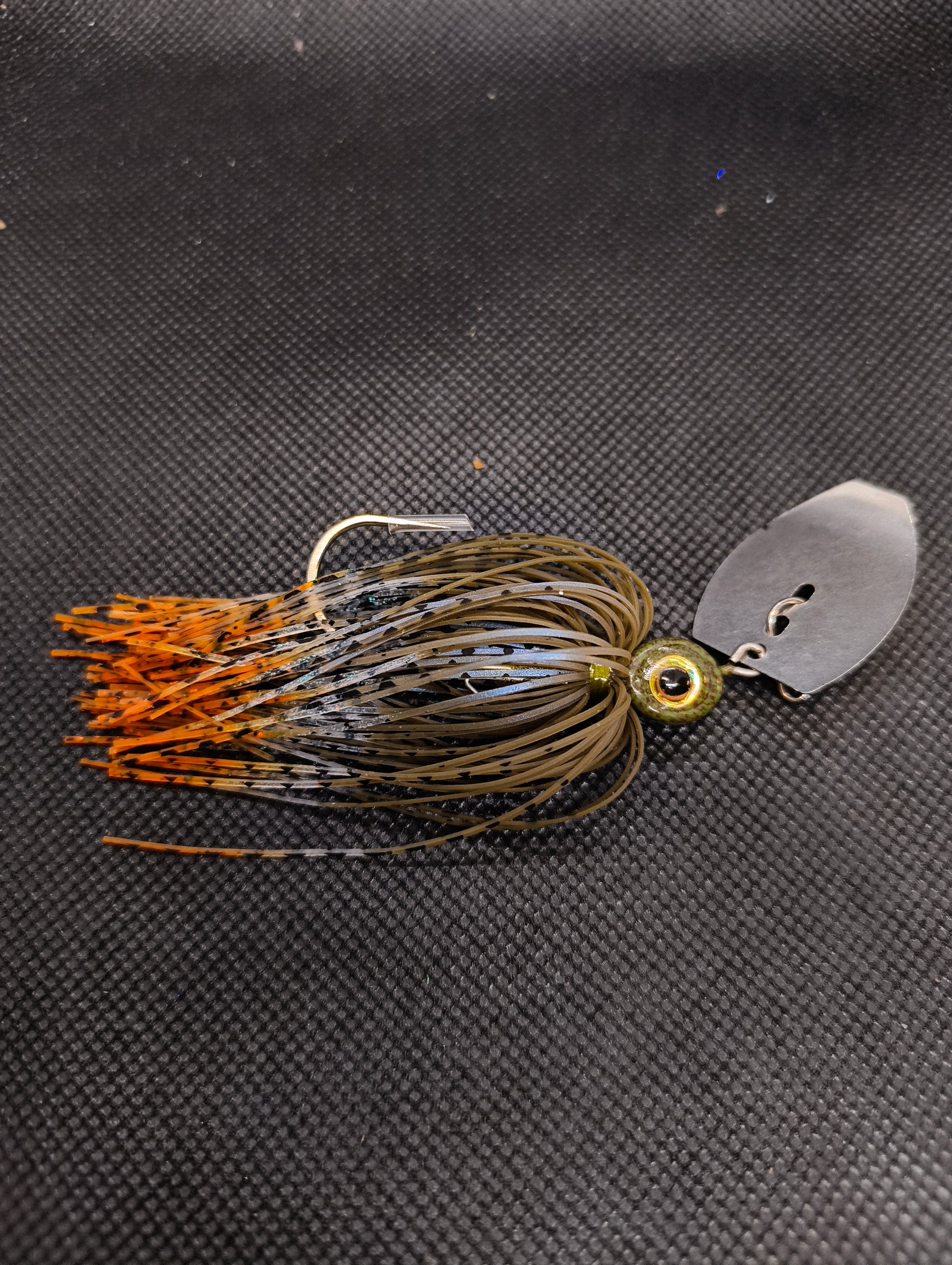 Limestone Softbaits ShadShaker chatter bait with green and black jig head and curly tail soft plastic for fishing.