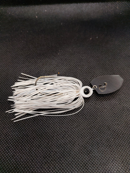 Limestone Softbaits ShadShaker chatter bait with a sleek black and blue jig head and a flexible plastic shad body for fishing.
