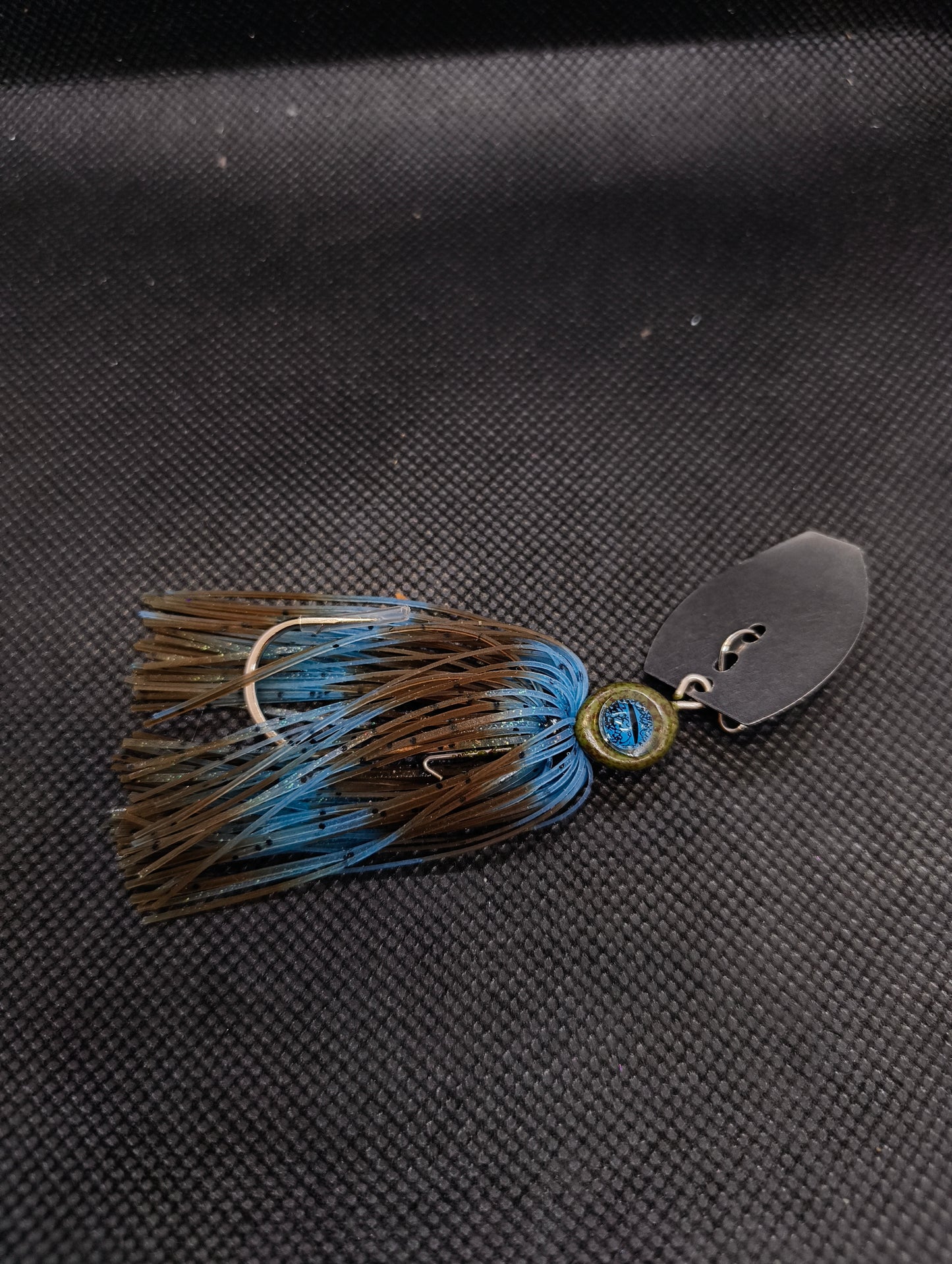 Limestone Softbaits ShadShaker chatter bait with black and blue skirt and metal blade, designed for bass fishing.