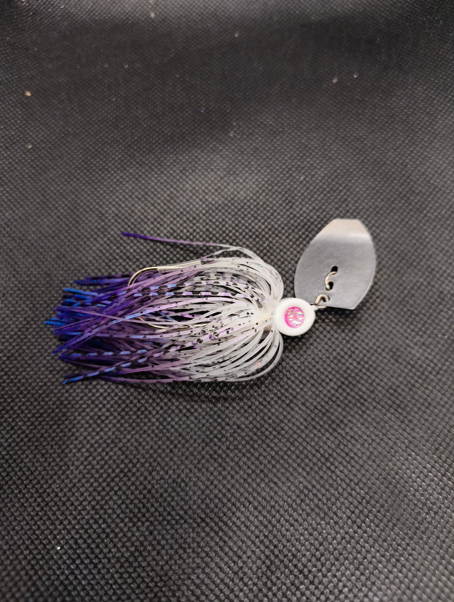 Limestone Softbaits ShadShaker chatter bait with a sleek blue and black design, featuring a metal blade and soft plastic shad body.