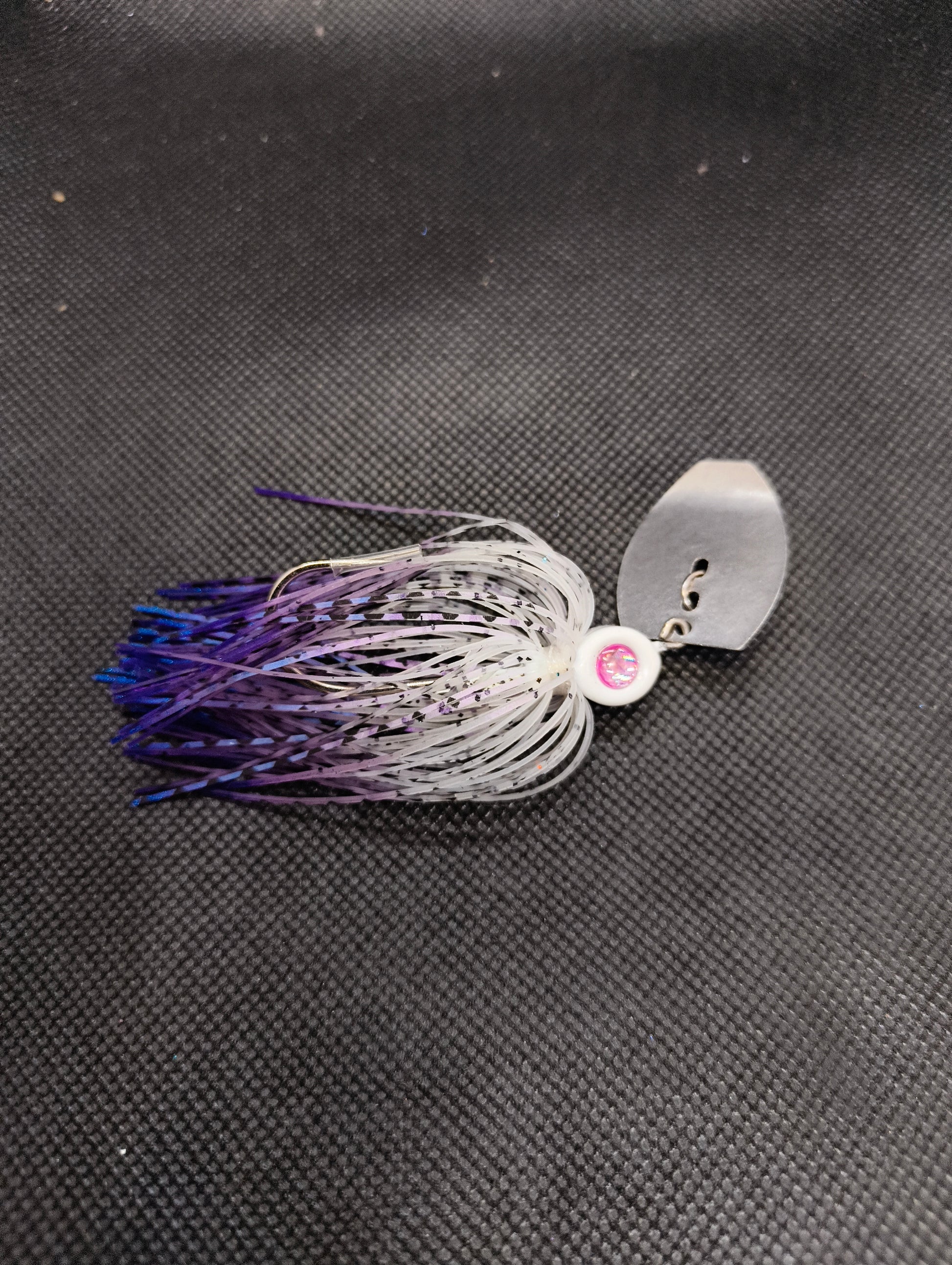 Limestone Softbaits ShadShaker chatter bait with a sleek blue and black design, featuring a metal blade and soft plastic shad body.