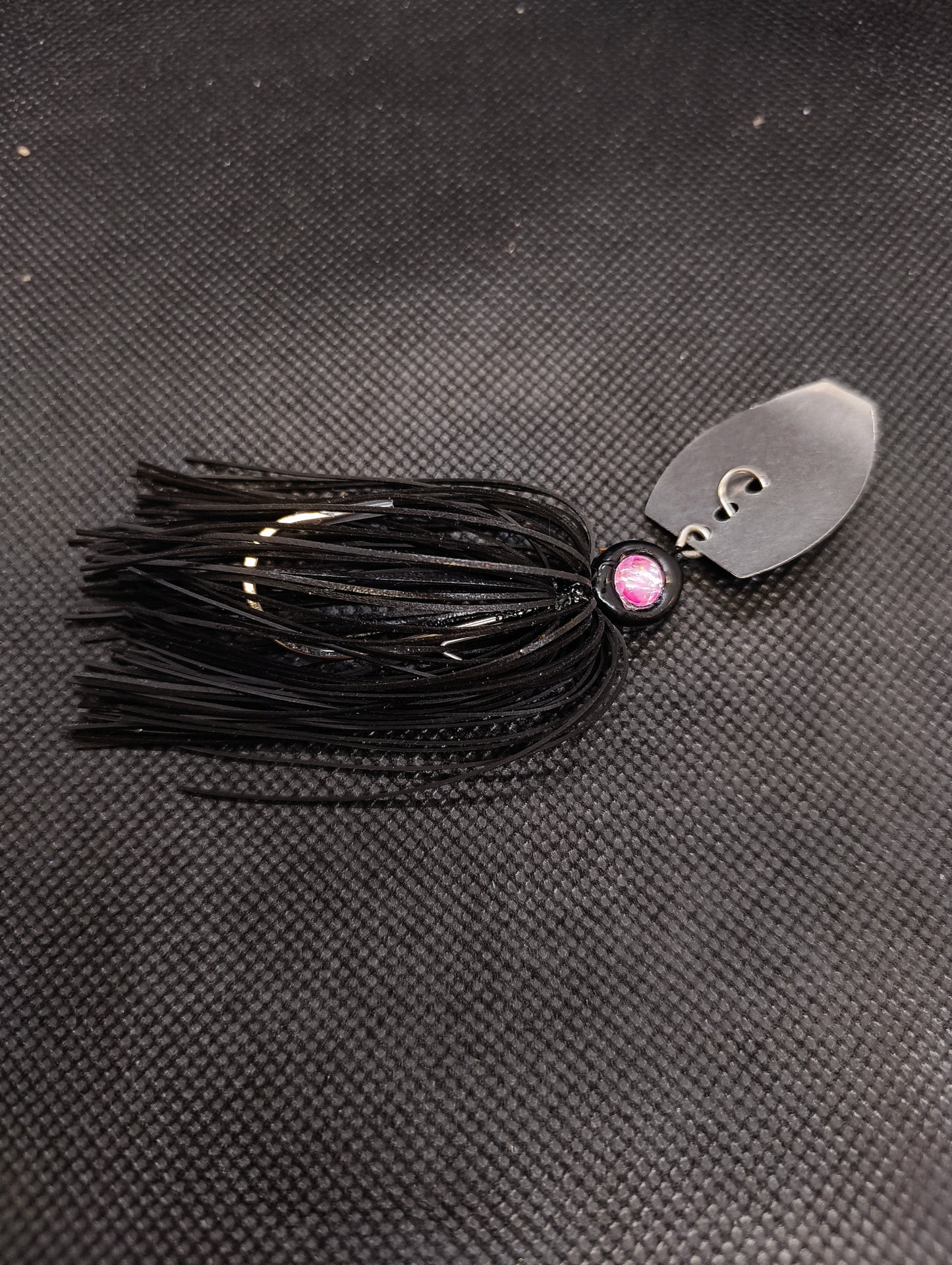 Limestone Softbaits ShadShaker chatter bait with a green and black skirt and metal blade for bass fishing.