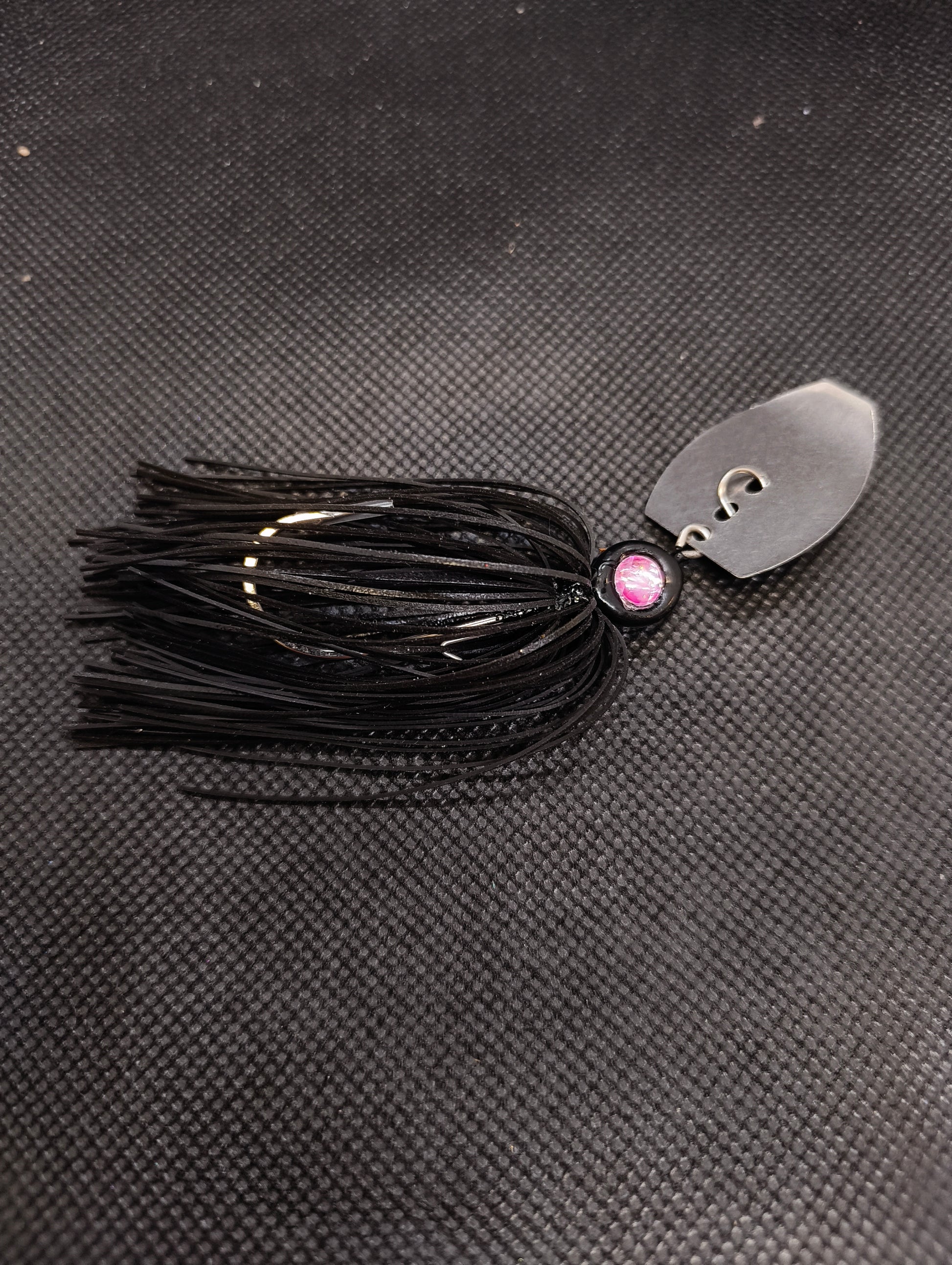 Limestone Softbaits ShadShaker chatter bait with a green and black skirt and metal blade for bass fishing.