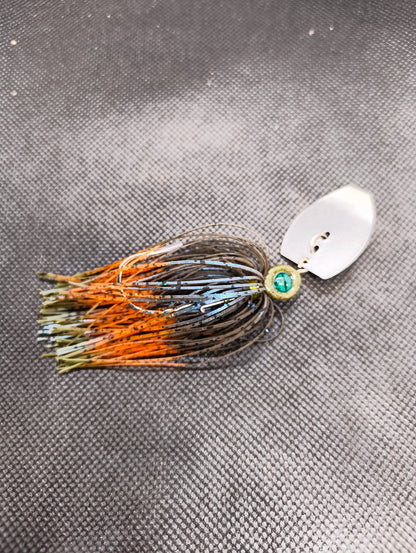 Limestone Softbaits ShadShaker chatter bait with a sleek, black and blue soft plastic lure attached to a fishing jig head.